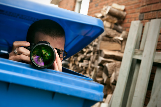 investigator hiding with camera to research divorce